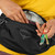 Person in a yellow top wearing the The Osprey Daylite Waist Pack removing a set of keys from the main pocket