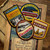 Wood table with folded map and 4 x badges from The Adventure Patch Company scattered over the top