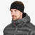 Person in jacket and facing left wearing a black Windjammer Headband by Montane
