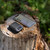 The Garmin inReach Messenger on a tree stump with a smartphone showing the app