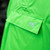 Up close shot of the Mac in a Sac Origin 2 Adult Neon Green Poncho front pocket