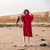 Person wearing the Dryrobe Organic Towelling Red Robe facing front on the beach