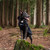 Dog wearing the the Mountain Paws Fleece Lined Dog Raincoat in black the forest