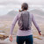 Woman wearing Montane Trailblazer 16 Backpack in moonscape purple on a hike