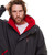 Close up of person wearing the Red Paddle Co Pro Change EVO Grey Long Sleeve Outdoor Robe partly unzipped to show the red lining with hood down