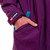 Close up of the front pocket on Red Paddle Co Pro Change EVO Mulberry Long Sleeve Outdoor Robe with a hand in the pocket showing the logo on the sleeve cuff