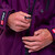Close up of the front zip on Red Paddle Co Pro Change EVO Mulberry Long Sleeve Outdoor Robe with a hand unzipping the robe