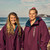 Two people on the beach wearing Red Paddle Co Pro Change EVO Mulberry Long Sleeve Outdoor Robe