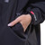 Close up of the front pocket on Red Paddle Co Pro Change EVO Stealth Black Long Sleeve Outdoor Robe with a hand in the pocket showing the logo on the sleeve cuff