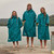 Three people standing next to a lake wearing  the Red Paddle Co Pro Change EVO Teal Long Sleeve Outdoor Robe next to the lake