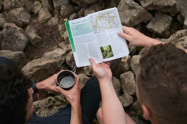 Two people looking at a Pathfinder Walking Guidebook