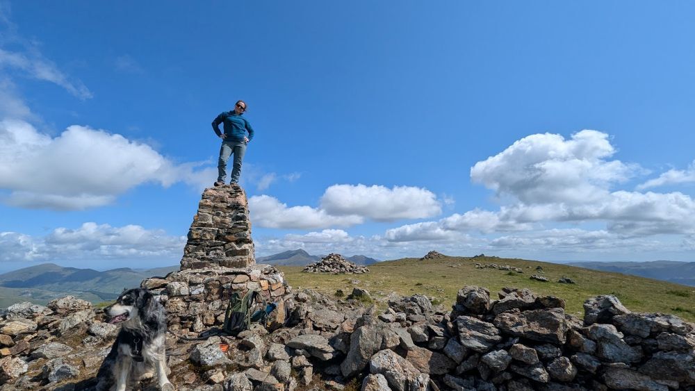 Person standing on a trig pillar