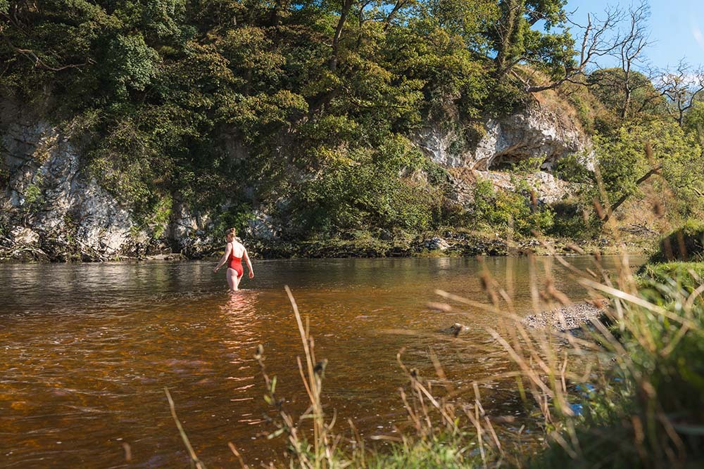 Woman wading in a river