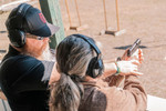 Firearms instructor providing 1-on-1 pistol coaching at a Michigan shooting range for 1791 Tactical Arms Training.