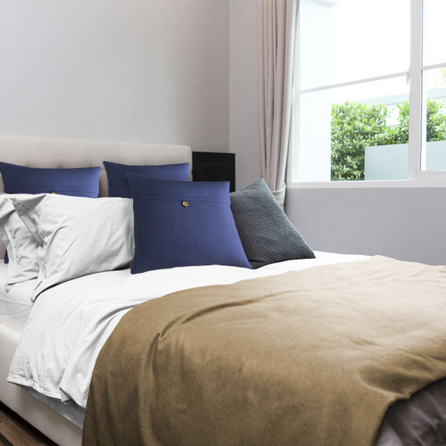 Polartec fleece blanket folded down on bed