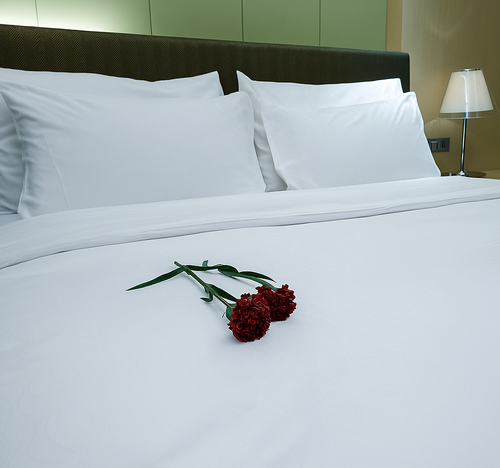 Heritage percale sheet set with flowers on bed