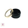 High end black beauty makeup container with a gold trim acrylic window lid sitting next to the jar