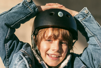 A Lost and Found Label on a child's black helmet.