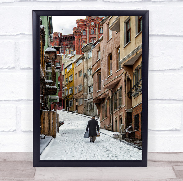 Walking In Balad man bags snowy path buildings Wall Art Print