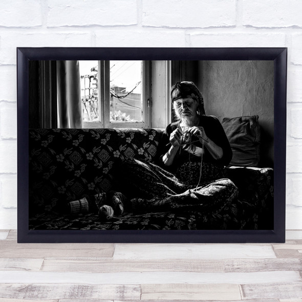 Old woman sewing black and white sofa window Wall Art Print