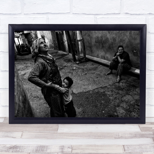 Child hugging mother street black and white Wall Art Print