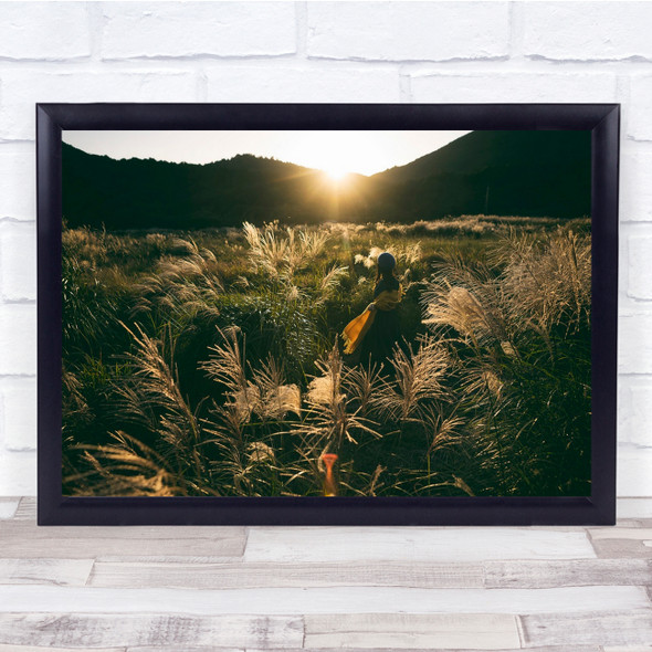 Adventurer woman in reed field sunset Wall Art Print