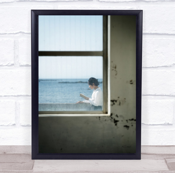 Window woman reading book ocean Wall Art Print
