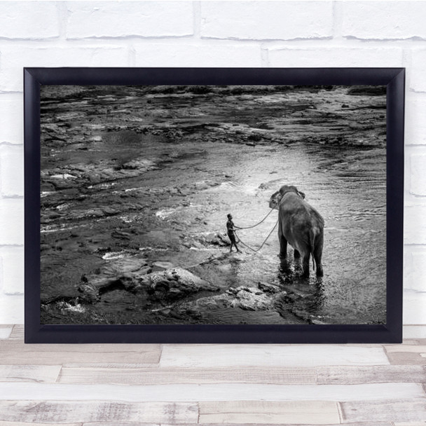 Elephant Being Led To Water By Man Wall Art Print