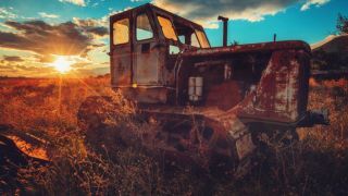 Old rusty tractor in a field