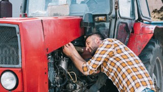 Farmer working on tractor