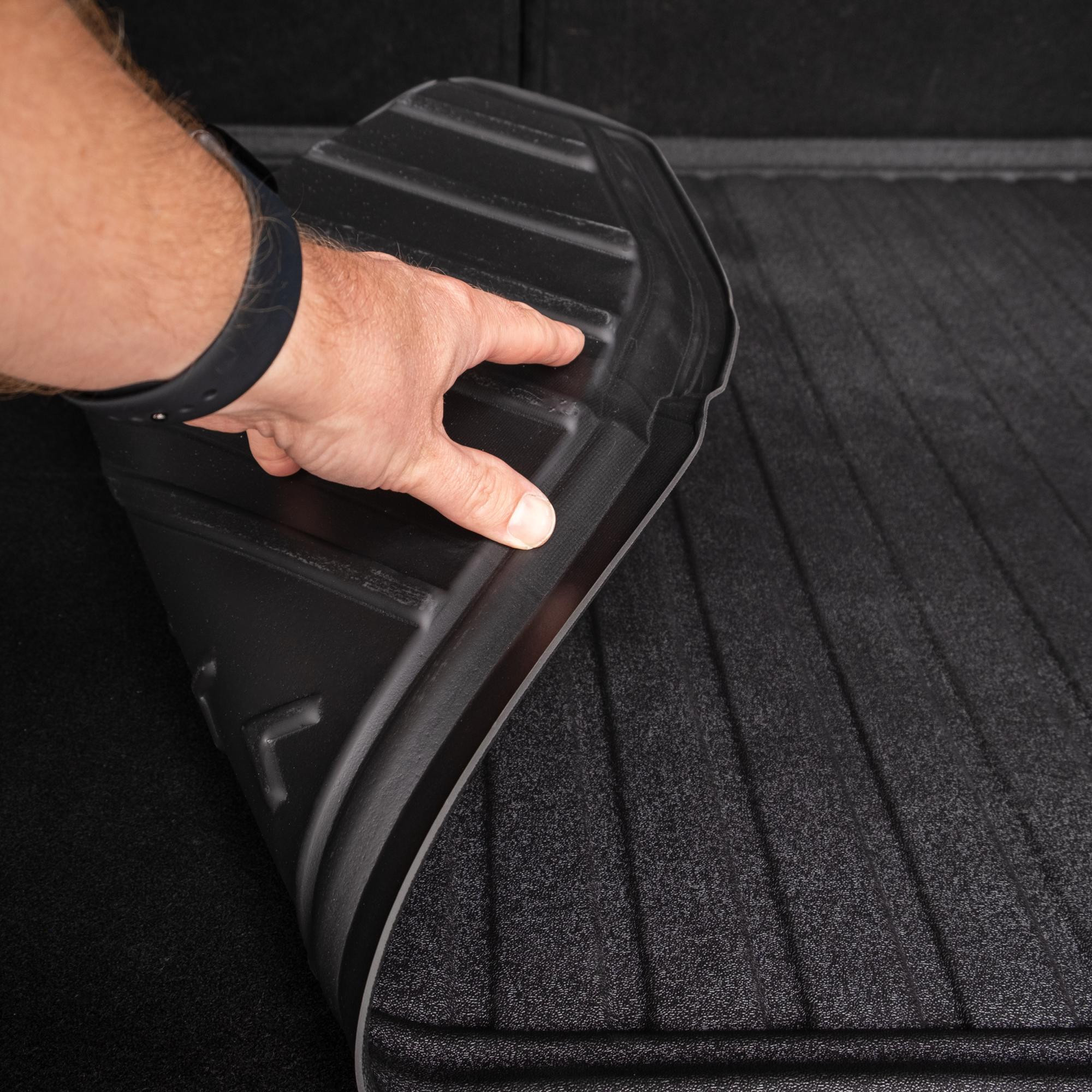 Flexible DriveDen boot mat for Ford Kuga Mk.2 being bent by hand