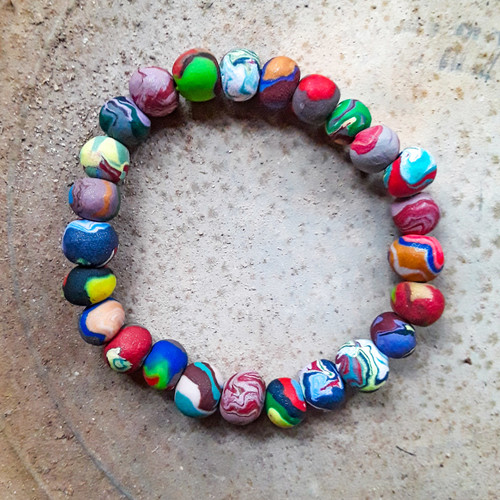 Handmade clay beaded bracelet set on an elastic band. Fits the average medium woman's wrist. Each beaded bracelet is unique. The pictured bracelets are for display only.