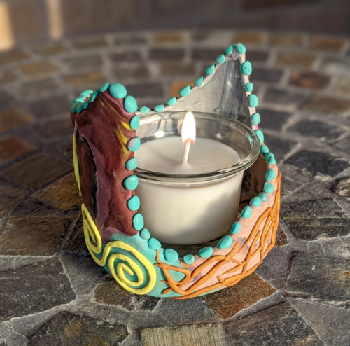 Handmade clay-wrapped specially shaped glass jar. Multiple uses including but not limited to candle holder. Purchase includes vanilla scented handmade candle.