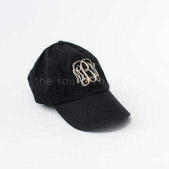 A black baseball hat with white monogrammed letters.