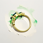 18kt gold unique women’s ring featuring oval emerald and natural diamonds