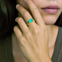 oval emerald ring on models hand 18kt gold