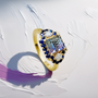 Unique women’s ring featuring bi-color tourmaline with sapphire and diamond accents