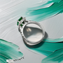 Top down view of emerald-cut emerald center with diamond halo