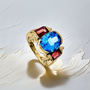 Oval blue topaz garnet statement ring front view