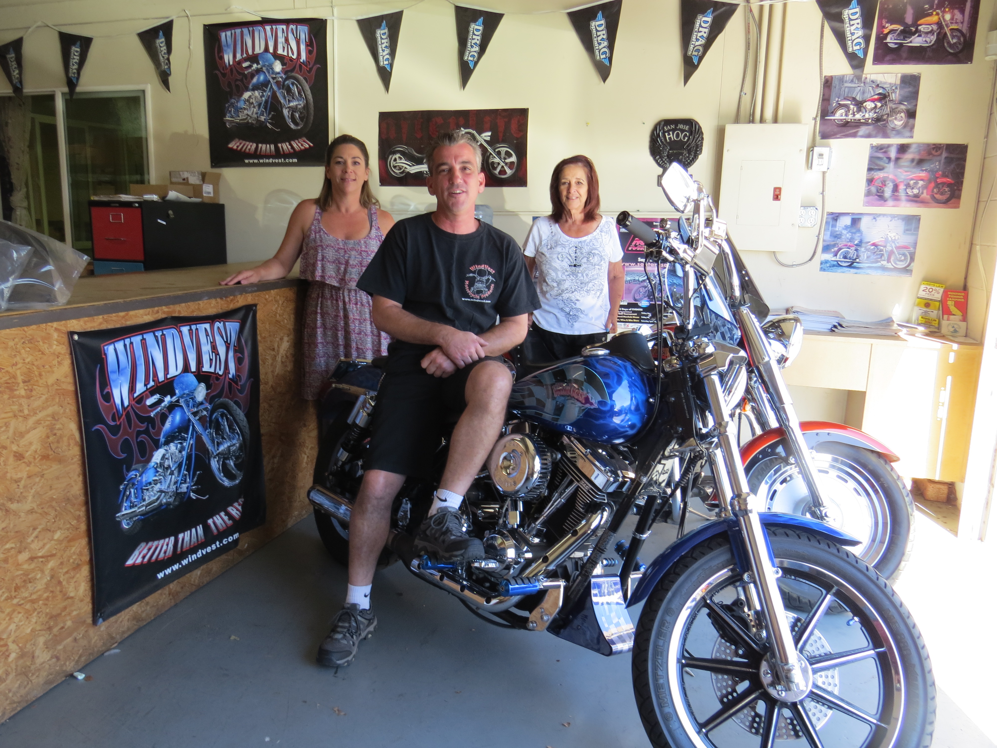 Photo by Marty Creek of Tami Dober, Doug Dober, Marilyn Dober at WindVest Windshields Motorcycle store