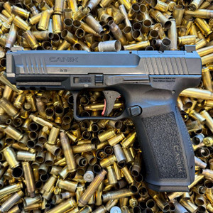 CANIK METE SFT One Series 9mm full size pistol with 4.46 inch barrel, optics ready slide, and black Cerakote finish, in store image on top of ammo casings