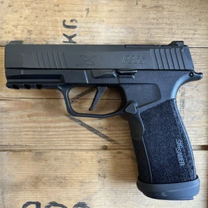 Sig Sauer P365 XMacro TACOPS 9mm pistol with 3.7 inch barrel, optics ready slide, XRAY3 night sights, and black finish facing left, in store image