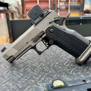 Vudoo Gun Works Priest DS double-stack 1911 pistol in Tungsten Grey featuring an RMR optic cut, flush-cut bull barrel, Red Dirt trigger, Vudoo Tactical Magwell, and aggressive aluminum grip, in store image