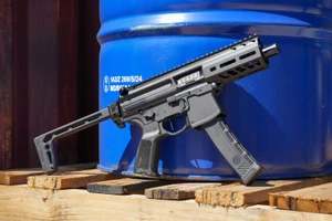 Sig Sauer MPX 9mm short-barreled rifle with 4.5 inch barrel folding stock and black M-LOK handguard, pointed to the right