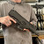 Springfield Kuna 9mm semi automatic pistol with 6 inch threaded barrel M-LOK handguard and black finish in store image held