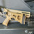Grand Power Stribog SP9A3S 9mm pistol in Flat Dark Earth with folding brace and threaded barrel, in store image with brace folded pointed to the right