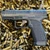 CANiK METE MC9 Prime compact 9mm pistol with compensated slide, optics-ready design, and night sights, in store image, on top of ammo casings