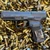 CANiK METE SF One Series compact 9mm pistol with optics-ready slide and black Cerakote finish, in store image on top of ammo casings