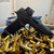 Sig Sauer P365 X Macro 9mm pistol with 4.3 inch threaded barrel, Romeo X optic, and black finish on ammo casings angled downward to the right