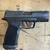 Sig Sauer P365 XMacro TACOPS 9mm pistol with 3.7 inch barrel, optics ready slide, XRAY3 night sights, and black finish facing right, in store image